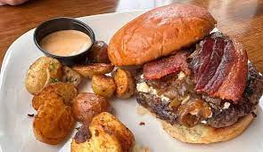 House of JuJu signature dishes  Various Gourmet Burgers (JuJu Bleu Burger, The Hangover Burger), Garlic Fries, Sweet Potato Fries, Fish Tacos, Salads.